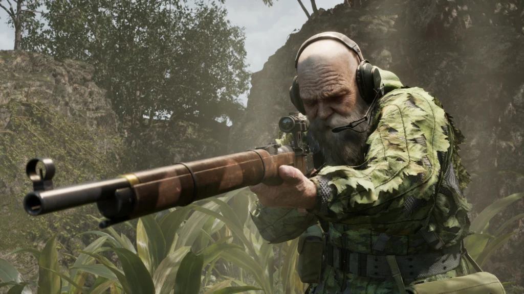 Cena do jogo Metal Gear Solid Delta: Snake Eater. The End, um franco-atirador idoso, se prepara para atirar com o seu rifle de precisão. The End é um homem caucasiano, careca, com uma barba grande e grisalha, usando uma veste militar decorada com folhas e um fone de ouvido preto na cabeça equipado com um microfone. Na sua cintura vemos várias bolsas presas no seu cinto. Ele está ajoelhado em meio à um matagal com pedras atrás de si e árvores em cima delas.