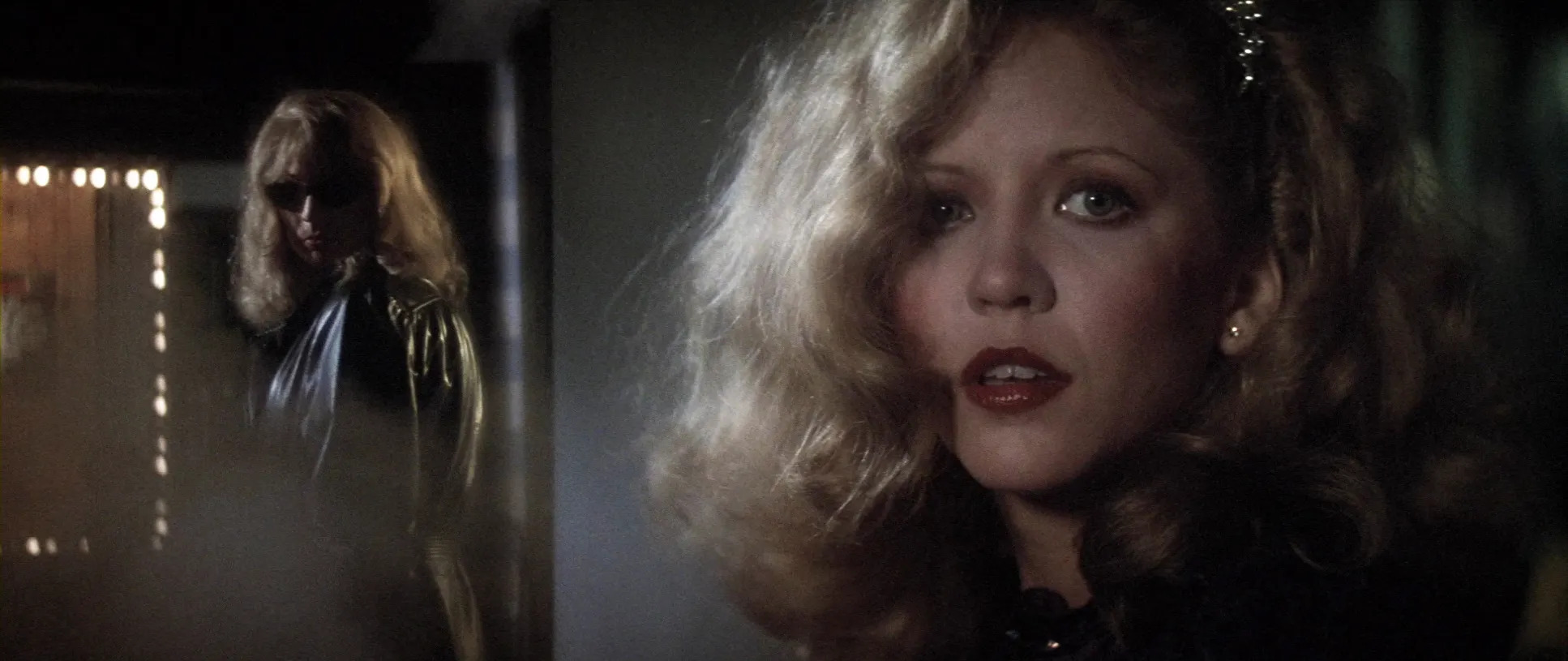 Fotografia das personagens Liz Blake e Bobbi. Bobbi está no lado esquerdo da imagem e olha discretamente para a direção de Liz. Liz, por sua vez, está na parte direita da imagem e olha para a frente com uma expressão facial que indica preocupação.